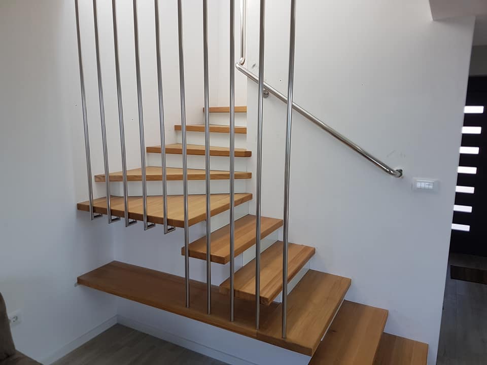 Wooden staircase with inox handrail